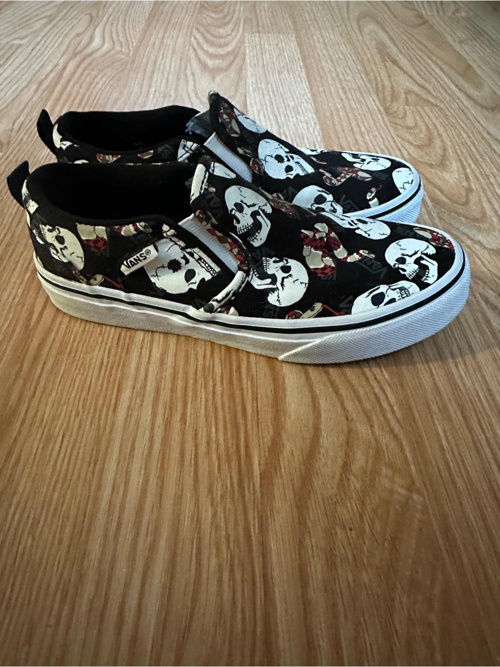 Vans Black Slip-On Sneakers with White Skulls and Red Rose Accents size 2
